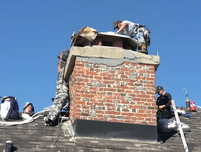 Westerly Chimney Sweep installing a custom chimney crown in Westerly, RI